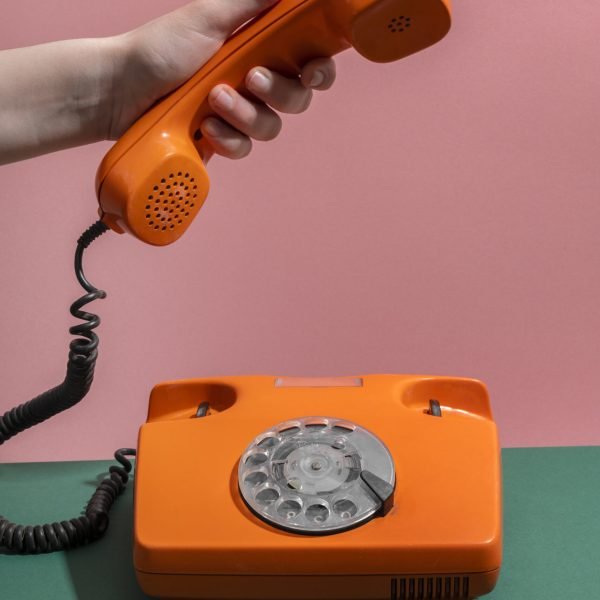 orange-phone-green-table-high-angle
